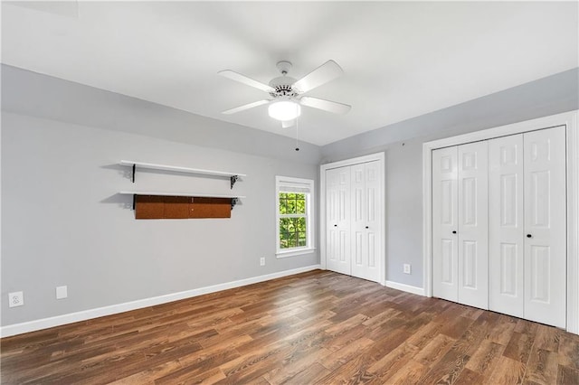 104 Ferncliff Cir, Daphne, AL 36526 - unfurnished bedroom featuring two closets, wood finished floors, baseboards, and a ceiling fan