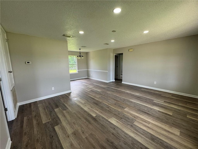 7684 Broome Ct, Theodore, AL 36582 - unfurnished room featuring a textured ceiling, dark wood finished floors, recessed lighting, and a chandelier