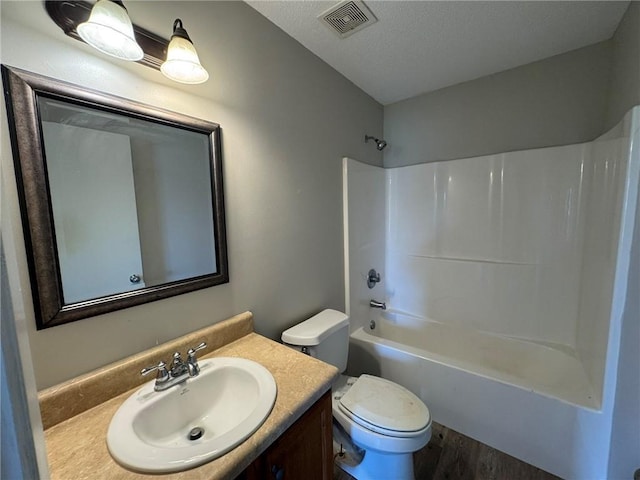 7684 Broome Ct, Theodore, AL 36582 - full bathroom featuring vanity, wood finished floors, shower / bath combination, and a textured ceiling