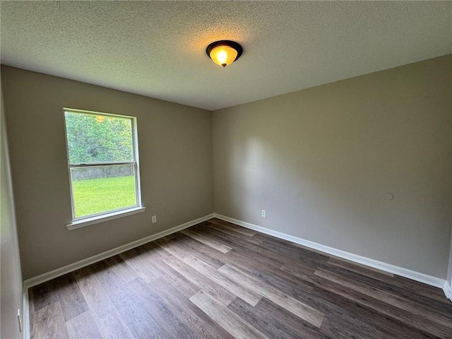7684 Broome Ct, Theodore, AL 36582 - empty room with dark wood-style floors and a textured ceiling