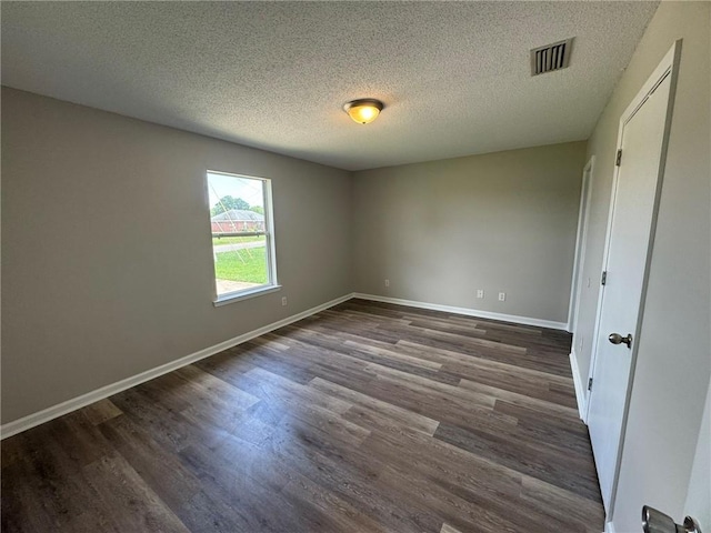7684 Broome Ct, Theodore, AL 36582 - unfurnished bedroom featuring dark wood-style flooring and a textured ceiling