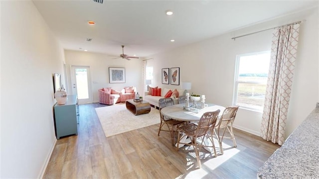 dining area featuring ceiling fan and light hardwood / wood-style flooring