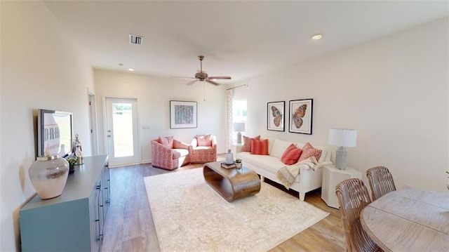 living room with ceiling fan and light wood-type flooring