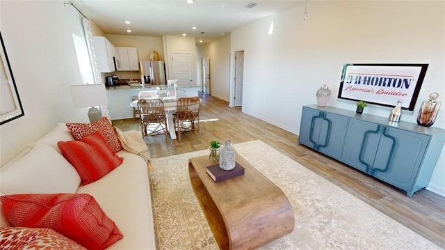 living room with light hardwood / wood-style flooring