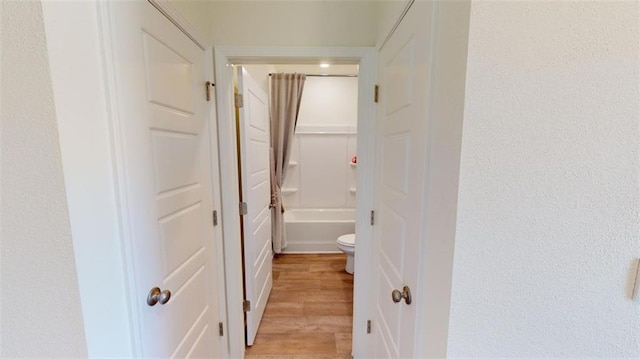 hallway with light hardwood / wood-style flooring