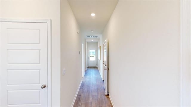 hallway with wood-type flooring