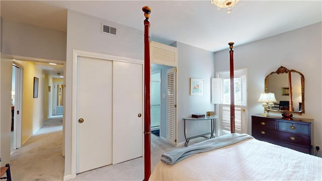 bedroom featuring light colored carpet and a closet