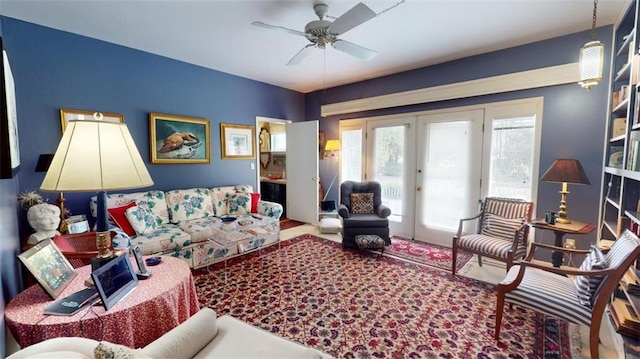 living room featuring ceiling fan and french doors