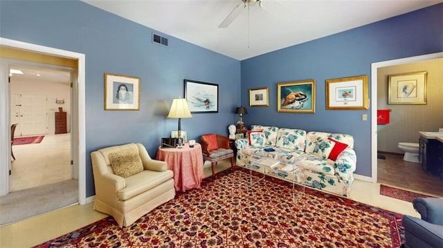 living room with ceiling fan and carpet