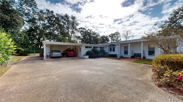 ranch-style home featuring a carport