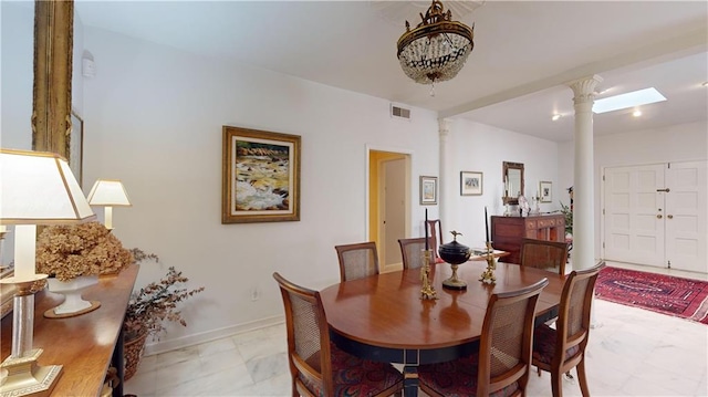 dining space with ornate columns