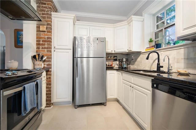 kitchen with white cabinets, dark stone countertops, extractor fan, a sink, and appliances with stainless steel finishes