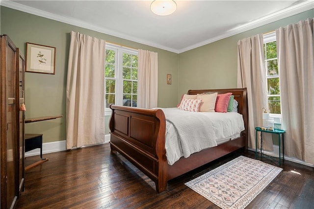 bedroom with hardwood / wood-style floors, baseboards, crown molding, and multiple windows