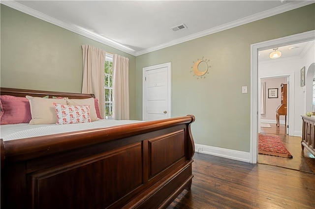 bedroom with arched walkways, visible vents, baseboards, crown molding, and dark wood-type flooring