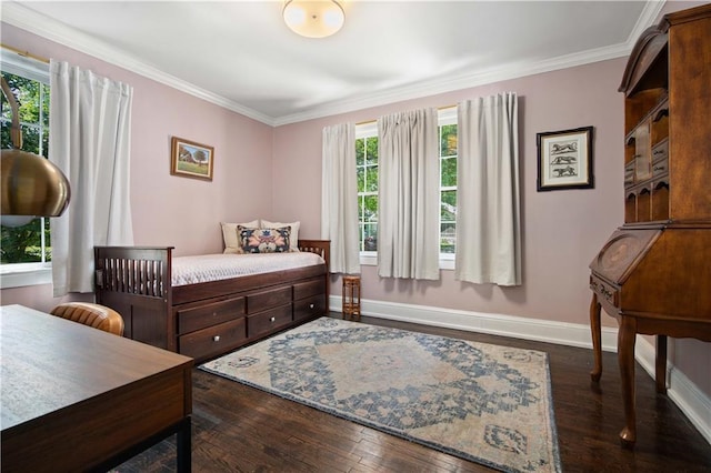 bedroom featuring wood finished floors, crown molding, and baseboards