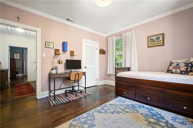 bedroom featuring attic access, baseboards, visible vents, wood finished floors, and ornamental molding
