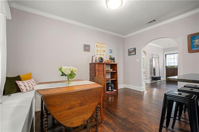 dining area with visible vents, arched walkways, dark wood-type flooring, crown molding, and baseboards