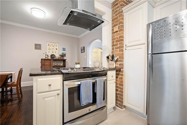 kitchen with white cabinetry, brick wall, crown molding, and stainless steel appliances