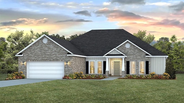 view of front of property featuring a garage and a yard