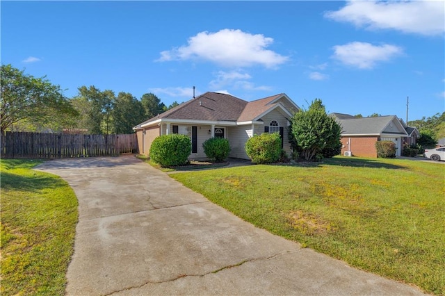 view of front of home with driveway, a front yard, and fence