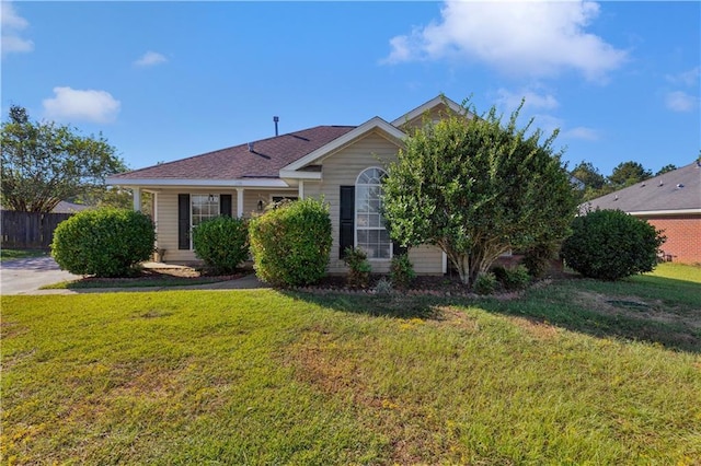 obstructed view of property featuring a front lawn and fence