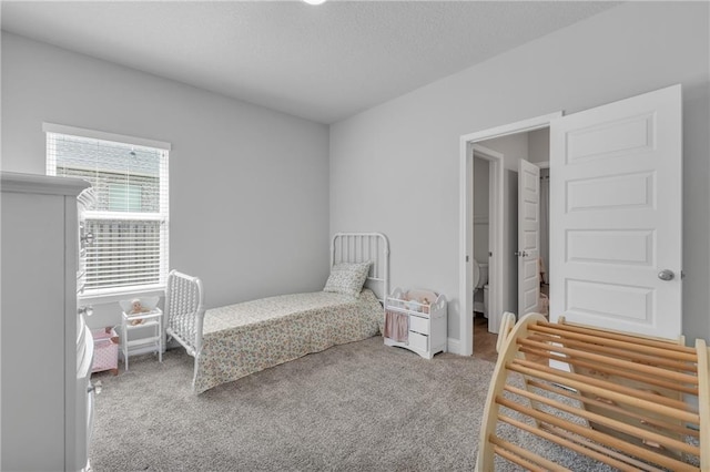 bedroom with carpet and a textured ceiling