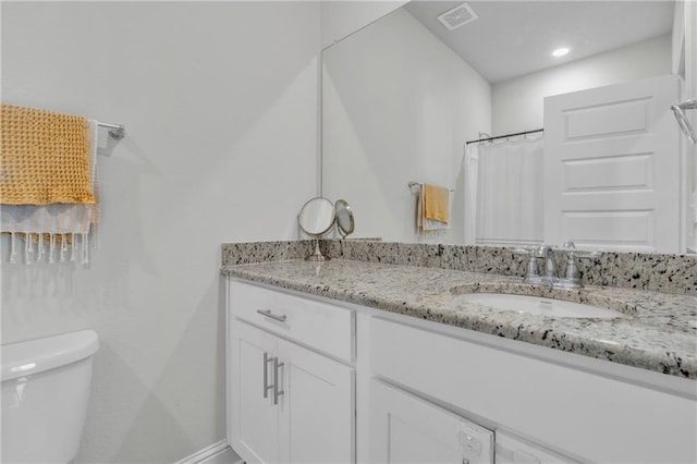 full bathroom with toilet, visible vents, and vanity