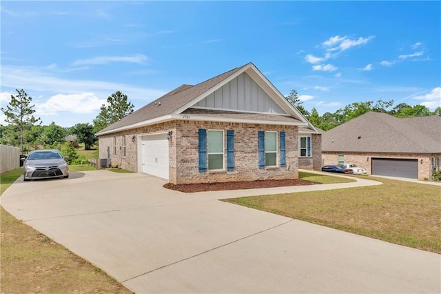 view of front of house featuring brick siding, driveway, a garage, a front yard, and board and batten siding