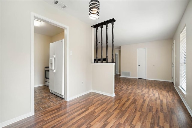 spare room with dark wood-type flooring