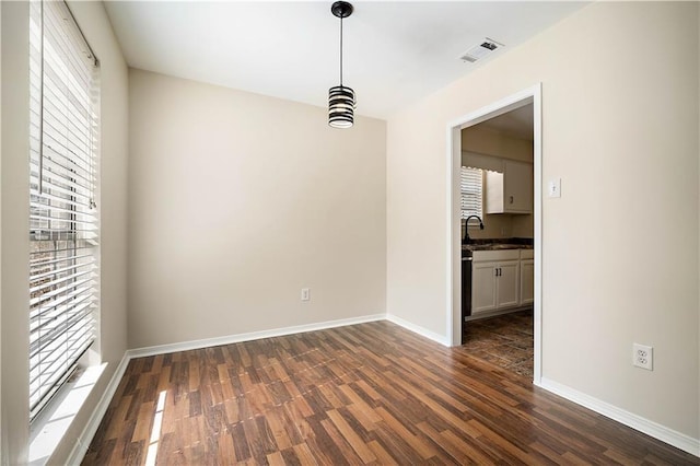 unfurnished room featuring sink and dark hardwood / wood-style flooring