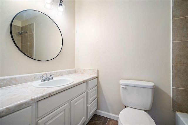 bathroom featuring vanity, toilet, and a tile shower