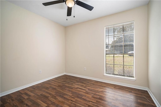 empty room with plenty of natural light, dark hardwood / wood-style floors, and ceiling fan