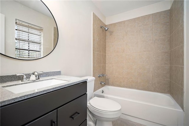 full bathroom with tiled shower / bath combo, vanity, and toilet