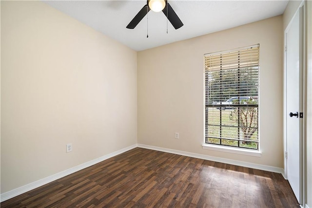 empty room featuring ceiling fan and dark hardwood / wood-style flooring