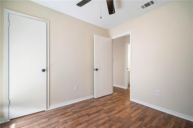 unfurnished bedroom with ceiling fan and dark hardwood / wood-style flooring