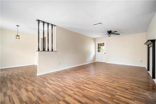 unfurnished living room featuring ceiling fan and wood-type flooring