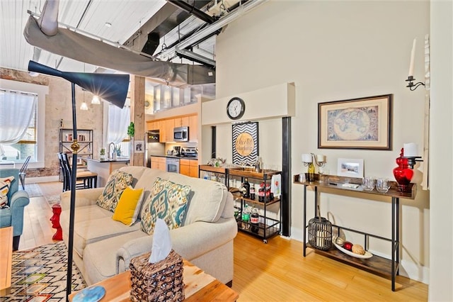 interior space with a towering ceiling and light wood-type flooring