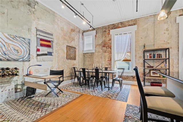 dining space featuring hardwood / wood-style floors and track lighting