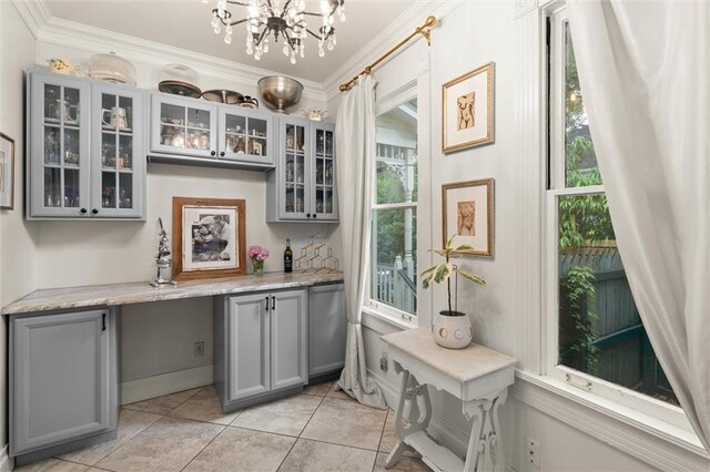 206 George St, Mobile, AL 36604 - indoor dry bar featuring ornamental molding, a chandelier, light tile patterned floors, dishwasher, and baseboards