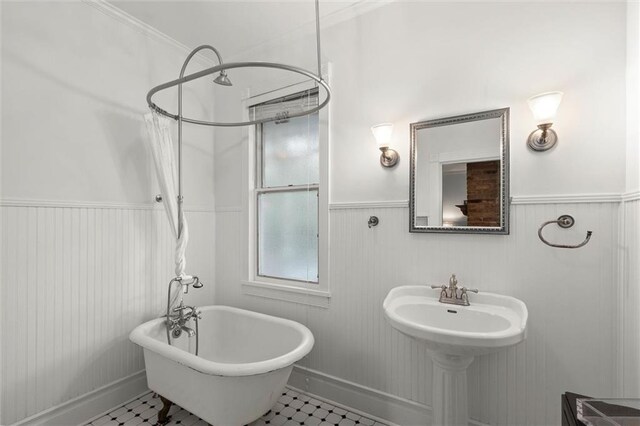 206 George St, Mobile, AL 36604 - full bathroom featuring a freestanding tub, wainscoting, tile patterned flooring, and a shower with shower curtain