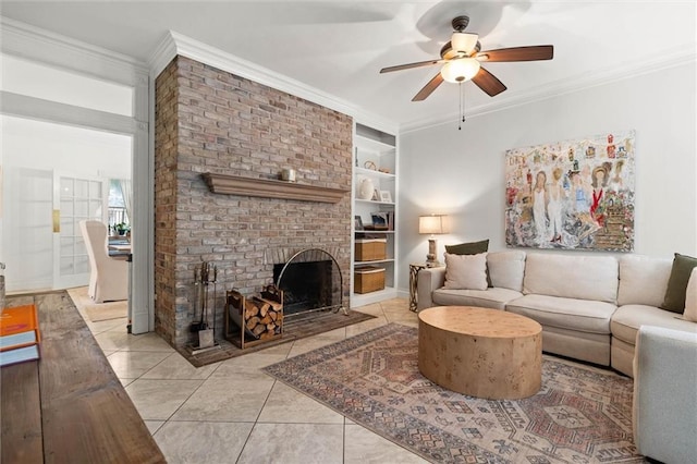206 George St, Mobile, AL 36604 - living room with a ceiling fan, a brick fireplace, built in shelves, ornamental molding, and light tile patterned floors
