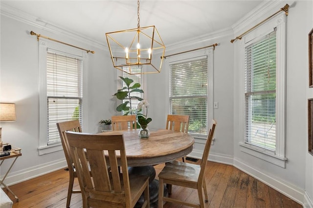 206 George St, Mobile, AL 36604 - dining room featuring a chandelier, hardwood / wood-style floors, baseboards, ornamental molding, and plenty of natural light