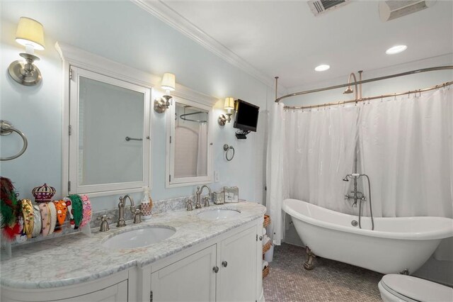 206 George St, Mobile, AL 36604 - full bathroom with a freestanding bath, double vanity, crown molding, toilet, and recessed lighting