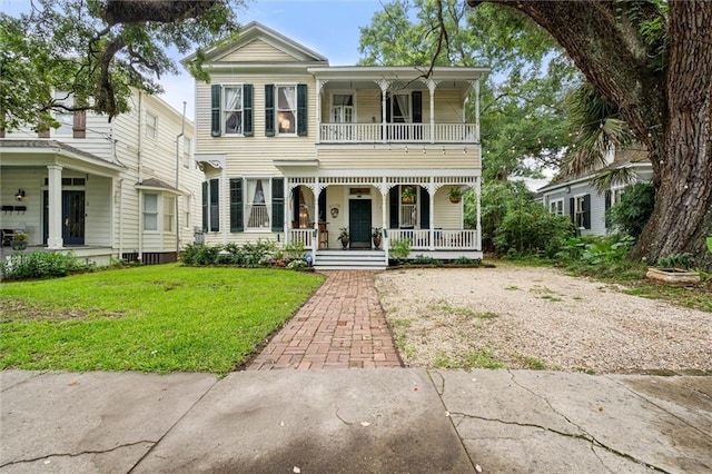 206 George St, Mobile, AL 36604 - view of front facade with covered porch, a balcony, and a front yard