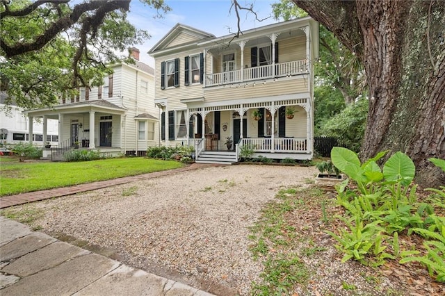 206 George St, Mobile, AL 36604 - view of front facade with a porch, a balcony, gravel driveway, and a front yard