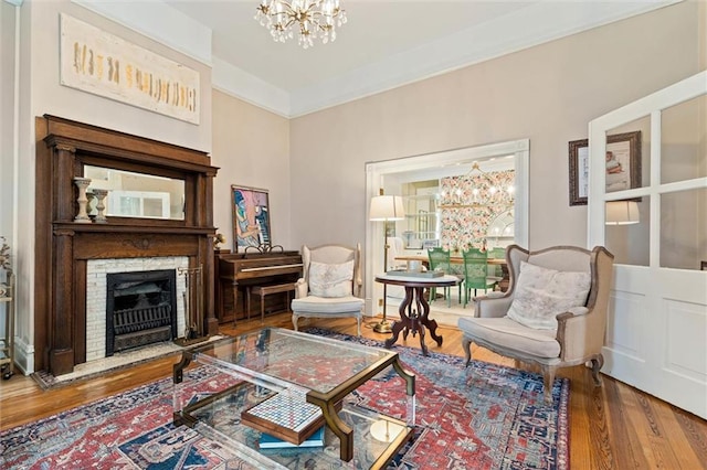 206 George St, Mobile, AL 36604 - sitting room with a chandelier, wood finished floors, and a fireplace