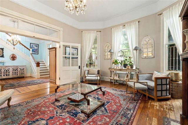 206 George St, Mobile, AL 36604 - sitting room featuring a chandelier, hardwood / wood-style floors, stairs, and baseboards