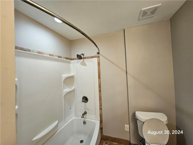 bathroom with toilet, tile patterned floors, and tub / shower combination