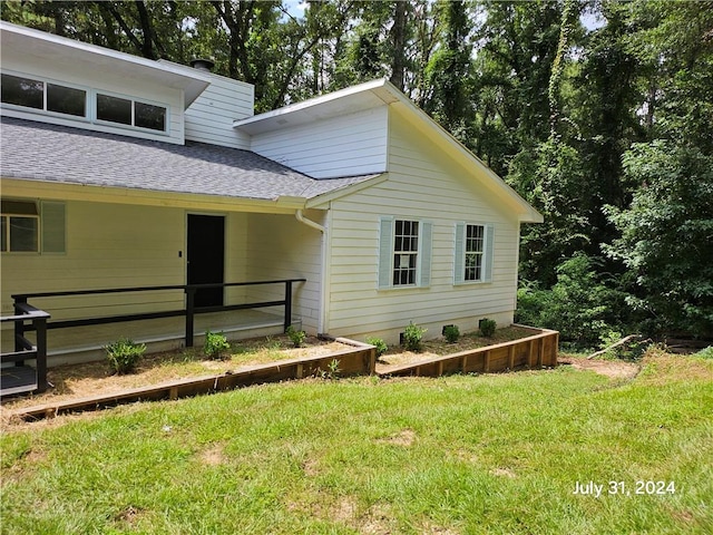 view of side of home featuring a lawn