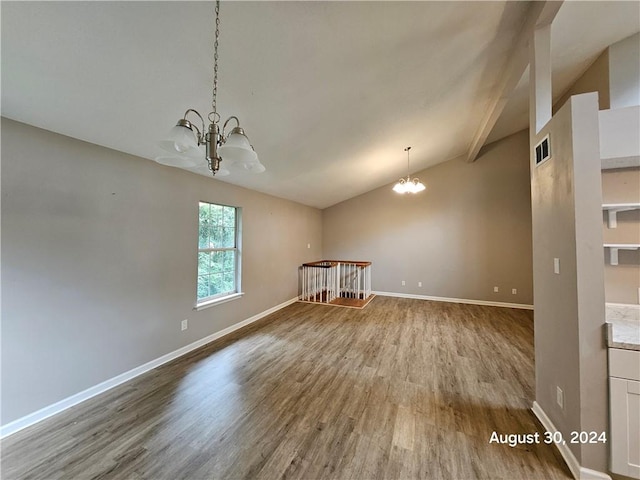 unfurnished room featuring lofted ceiling, a chandelier, and hardwood / wood-style floors